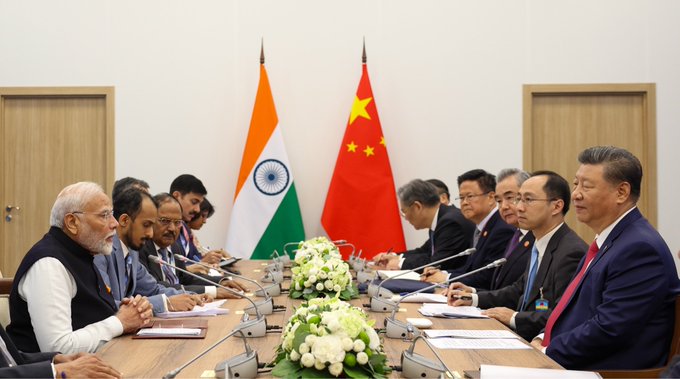 This image depicts a meeting between Indian Prime Minister Narendra Modi and Chinese President Xi Jinping, as India's record $15.2 billion purchase of U.S. Treasuries contrasts with China's reduced holdings.