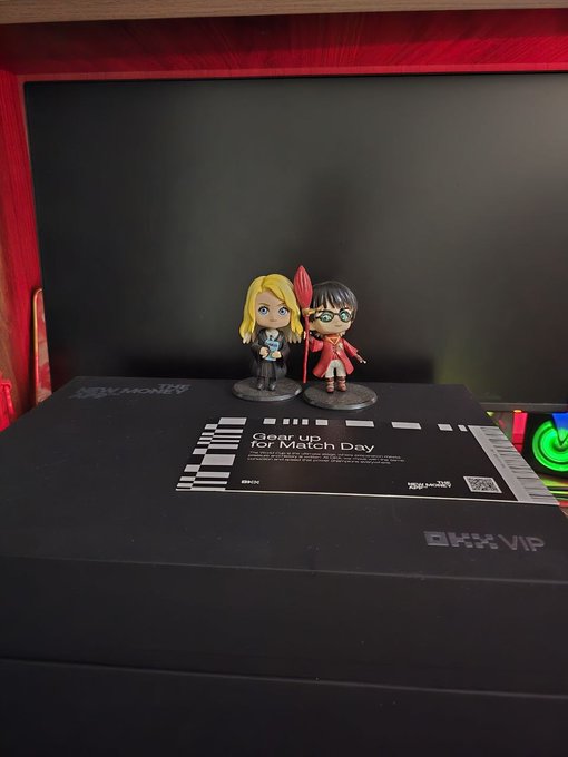 Two Funko Pop figures stand atop a sleek black "OKX VIP" box alongside a card labeled "Gear up for Match Day," showcasing the exclusive promotional gift the recipient is thanking OKX for.