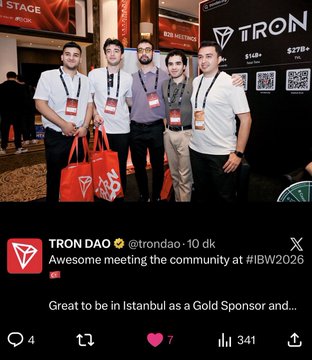 Five attendees stand together at the IBW2026 conference, posing in front of a TRON-branded booth with a Gold Sponsor backdrop, while a TRON DAO tweet celebrates the meeting with the community at the event. The image illustrates the post's message about the TRON and TRON DAO Turkish community's presence and engagement at the global blockchain gathering.