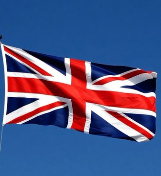A Union Jack flag waves against a clear blue sky.