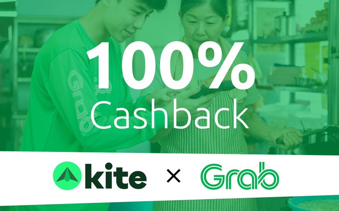 A promotional graphic with a green tint shows a young man and an older woman looking at a phone, with text reading '100% Cashback' and logos for 'kite' and 'Grab'.