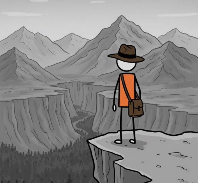 A simple stick figure wearing an orange shirt, brown fedora, and brown messenger bag stands on a cliff edge looking out over a vast grayscale mountainous canyon landscape.