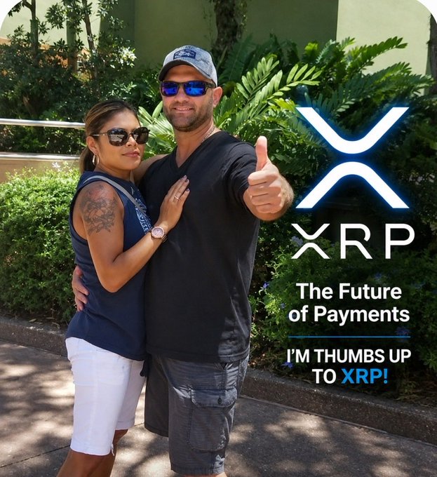 A man and woman pose together outdoors with the man giving a thumbs-up, accompanied by XRP crypto branding and text reading "The Future of Payments - I'M THUMBS UP TO XRP!".