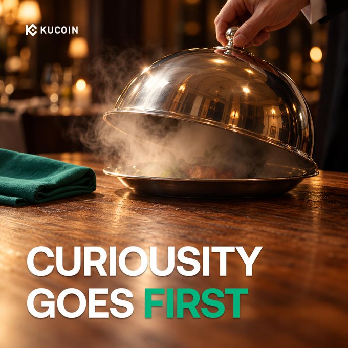 A hand lifts a silver cloche on a wooden restaurant table, releasing aromatic steam that hints at the dish beneath, alongside the KuCoin logo and the tagline "Curiosity Goes First." The image visually echoes the post's invitation to uncover rewards—mirroring the act of lifting a lid with the curiosity-driven prompt to complete campaign activities and trade for a chance to win 100 USDT.