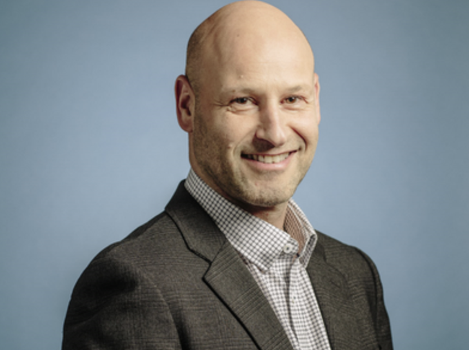 A headshot of a smiling, bald man in a brown blazer and checkered shirt against a blue background, likely Joseph Lubin given the accompanying post about Ethereum's growth strategy and expectations for widespread L1 and L2 adoption.