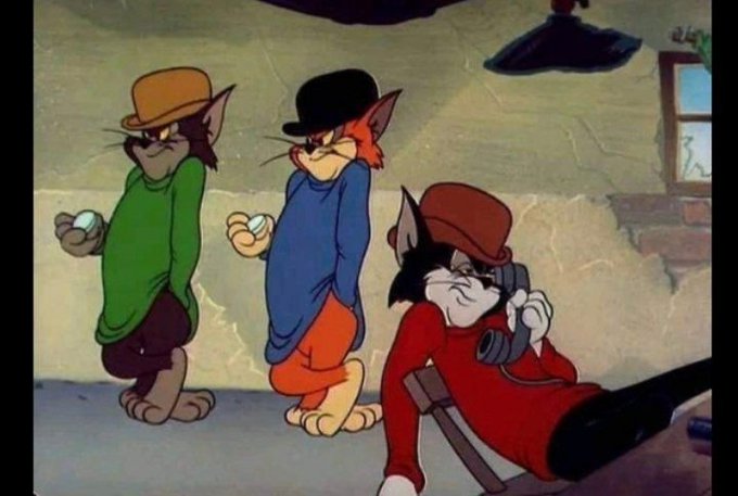 A scene from the animated cartoon Tom and Jerry showing Tom and two other cats in hats, with one cat on the phone looking at a rifle barrel.