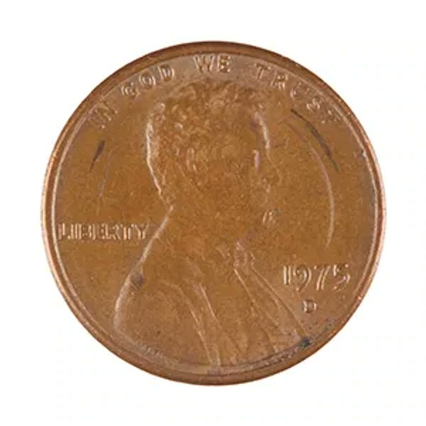 A close-up of a 1975-D US Lincoln penny showing the obverse with 'IN GOD WE TRUST,' 'LIBERTY,' and the date '1975 D' visible.