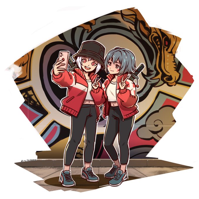 An anime-style illustration of two female characters in red jackets taking a selfie with a smartphone while holding pistols, posed in front of a graffiti-covered wall.