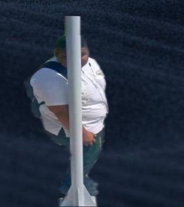 Two individuals in white shirts embrace behind a stadium pole, appearing to playfully hide from view. The image humorously illustrates the post's joke about someone being embarrassed by a $46 price, as the people are literally trying to "hide."
