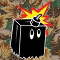 A pixel art image showing a black cube-like creature with eyes and jagged teeth against a camouflage background, with a red and yellow starburst explosion above it.