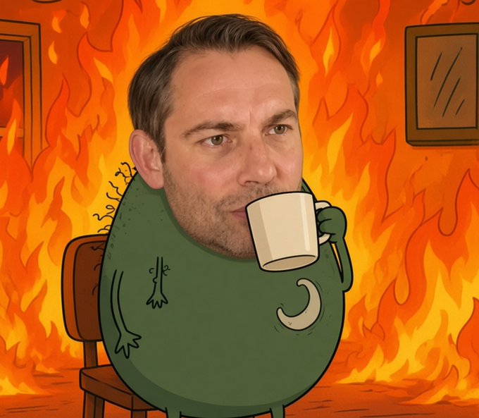 The caption should be: A man with a real human face pasted onto the cartoon "This is Fine" meme dog, calmly sipping coffee while surrounded by flames.

How it relates to the post: The image is a direct visual reference to the iconic "This is Fine" meme, where the dog/character dismissively sits amid chaos—perfectly matching the post's resigned tone of "Everything's down. This is fine. I'm fine." as markets tumble.