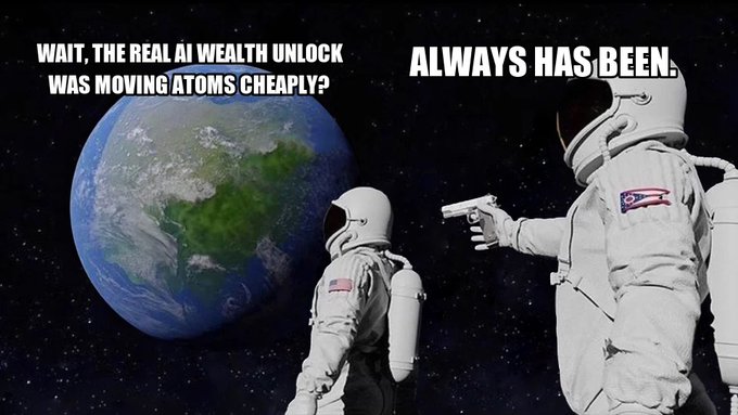 An 'Always Has Been' meme featuring two astronauts in space, where one holding a gun says 'WAIT, THE REAL AI WEALTH UNLOCK WAS MOVING ATOMS CHEAPLY?' and the other responds 'ALWAYS HAS BEEN.'