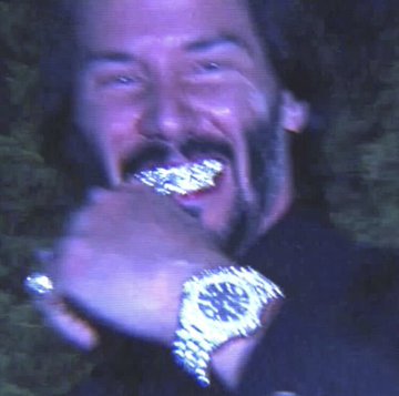 A low-quality image shows a man smiling and showing off a grillz mouthpiece and a large, jeweled watch.