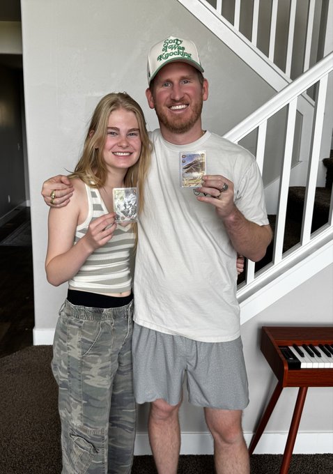 A man and a young girl smile together indoors, each proudly holding up what appear to be trading cards, with the man's green and white "Sorry for Partying" cap visible. The image captures a touching pre-purchase moment with his niece, reflecting the post's story of bonding over card packs before buying his original Azuki NFT to store long-term for his kids.