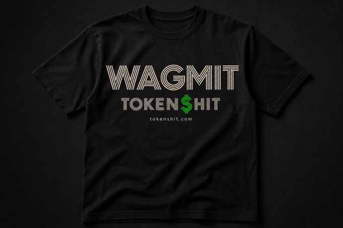 A black t-shirt design featuring the text 'WAGMIT' in striped lettering above 'TOKEN$HIT' with a green dollar sign, branded with tokenshit.com.