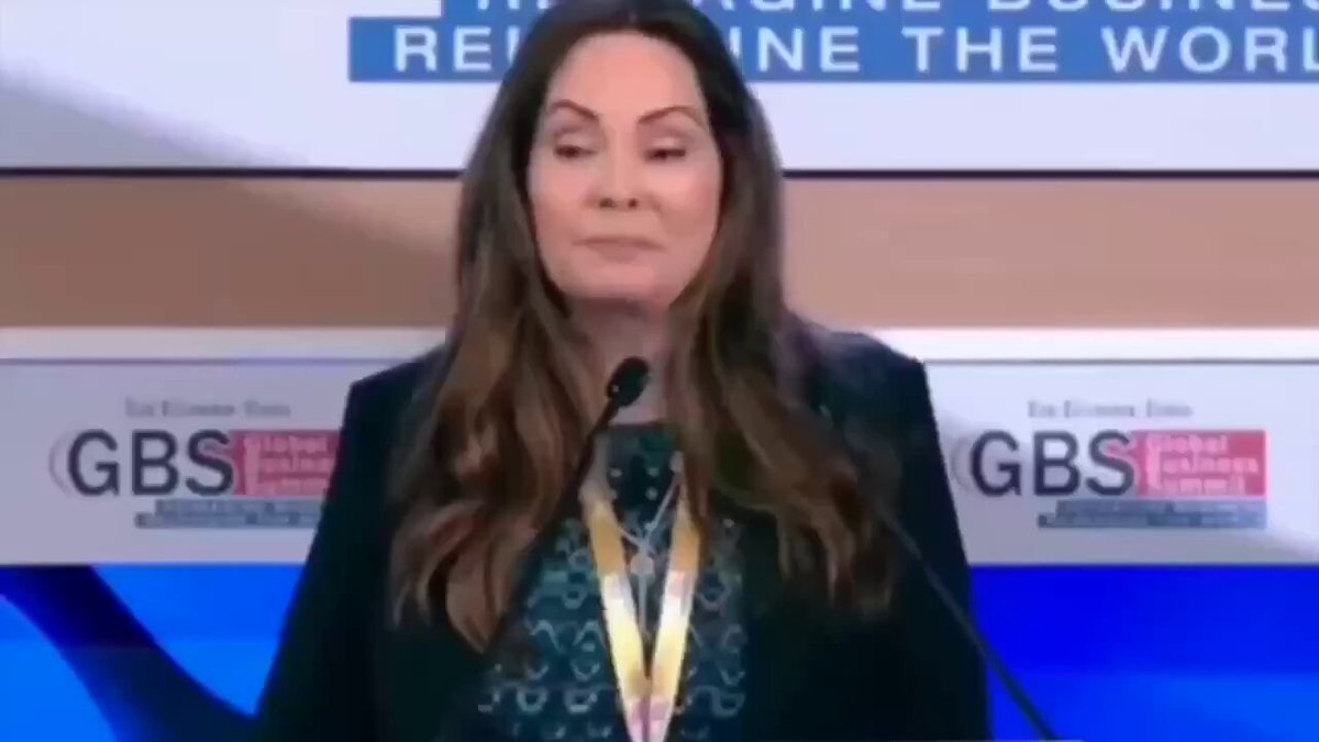 The image features Rosie Rios, who has been recognized for her work in the financial industry. She is standing at a podium with a microphone, giving a speech or presentation about Ripple and XRP. The background of the image shows a blue wall with white text that reads "The $XRP Ledger is expanding beyond banking and is now entering the massive media industry". This suggests that Rosie Rios has been involved in promoting Ripple and XRP to the media, possibly through her role as an expert or influencer.