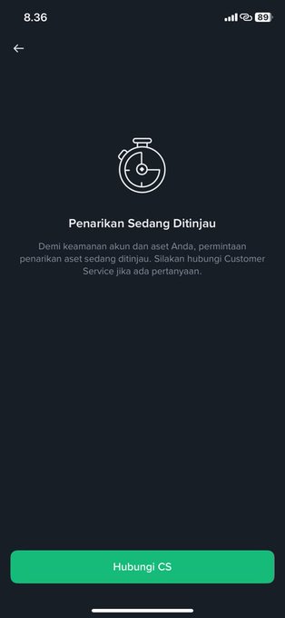 A mobile app screen in Indonesian showing a stopwatch icon with the text 'Penarikan Sedang Ditinjau' (Withdrawal Under Review), noting that for security reasons, the withdrawal request is being reviewed and to contact Customer Service if there are questions, with a 'Hubungi CS' button at the bottom.