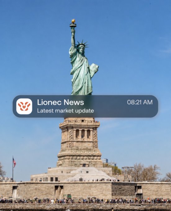 A daytime view of the Statue of Liberty on Liberty Island with an overlaid iOS notification banner from 'Lionec News' reading 'Latest market update' at 08:21 AM.