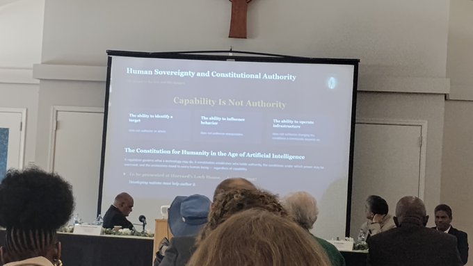 A presentation slide titled 'Human Sovereignty and Constitutional Authority: Capability Is Not Authority' displayed at what appears to be an AI governance event, with an audience and panelists visible in the foreground.
