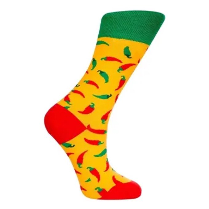 A single product image of a yellow crew sock featuring a pattern of red and green chili peppers, finished with a solid green cuff and red toe and heel.