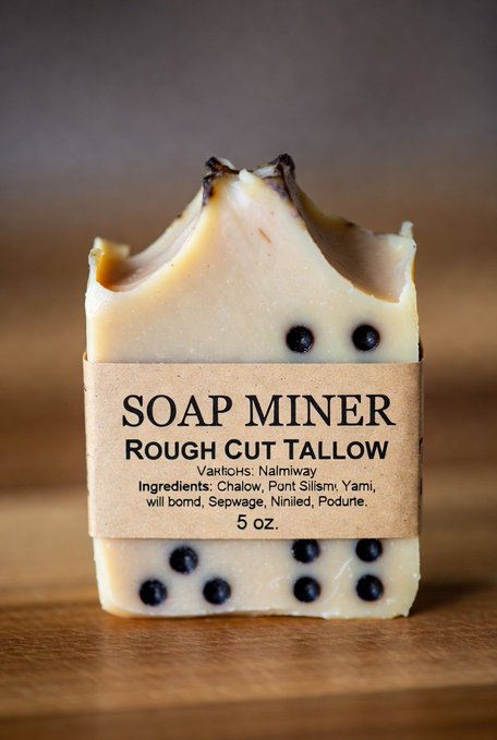 A bar of 'SOAP MINER Rough Cut Tallow' soap with ingredients listed (Chalow, Pont Slismy, Yami, will bomd, Sepwage, Niniled, Podute) and 5 oz label.