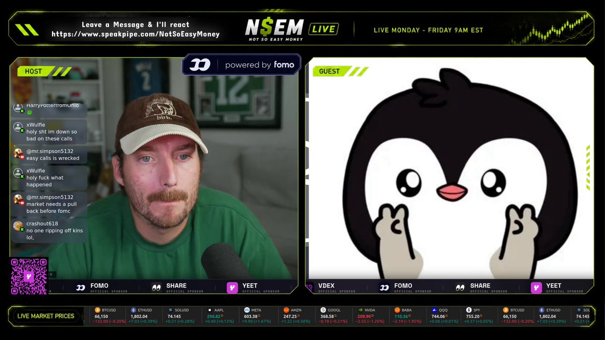 The image shows a man wearing a green shirt sitting at a computer desk with a screen displaying two penguin images. One penguin has its head tilted upwards while the other has its head down. The background of the image also includes text that reads "Liv Venkatesh Friday, Nov 8th". The man is wearing a hat and appears to be engaged in an online gaming session or streaming platform where he is either playing or giving a live stream.