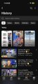 The image shows an iPhone screen displaying various movie options, including a history section with different movies available for viewing. The screen also has a search bar at the top that allows users to find specific content or browse through different categories of movies. There are several movie titles displayed on the screen, and some of them appear to be in a foreign language.