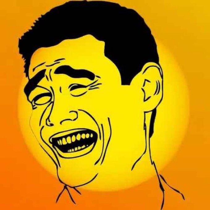urn of fire burns bright orange, casting a warm glow on the face of a man with black hair and a mustache, who is laughing heartily.