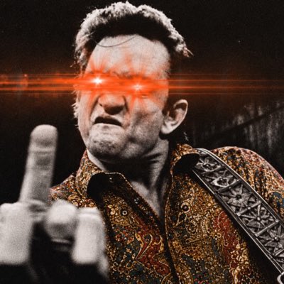 A man in a patterned shirt and guitar strap giving the middle finger, with a digital red laser-beam eye effect edited onto his face.