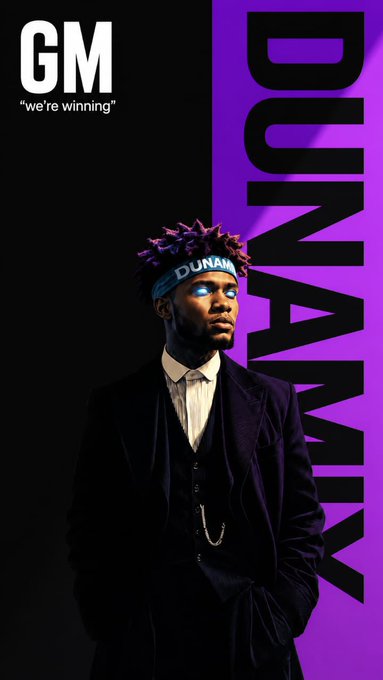 A man wearing a "DUNAMIX" headband and dark suit poses against a black and purple background, with "GM 'we're winning'" displayed in the top left and "DUNAMIX" written vertically in large letters on the right. The image aligns with the post's "Gm 𝕏 happy new week $ANSEM" message by promoting the $DUNAMIX token associated with crypto influencer Ansem.