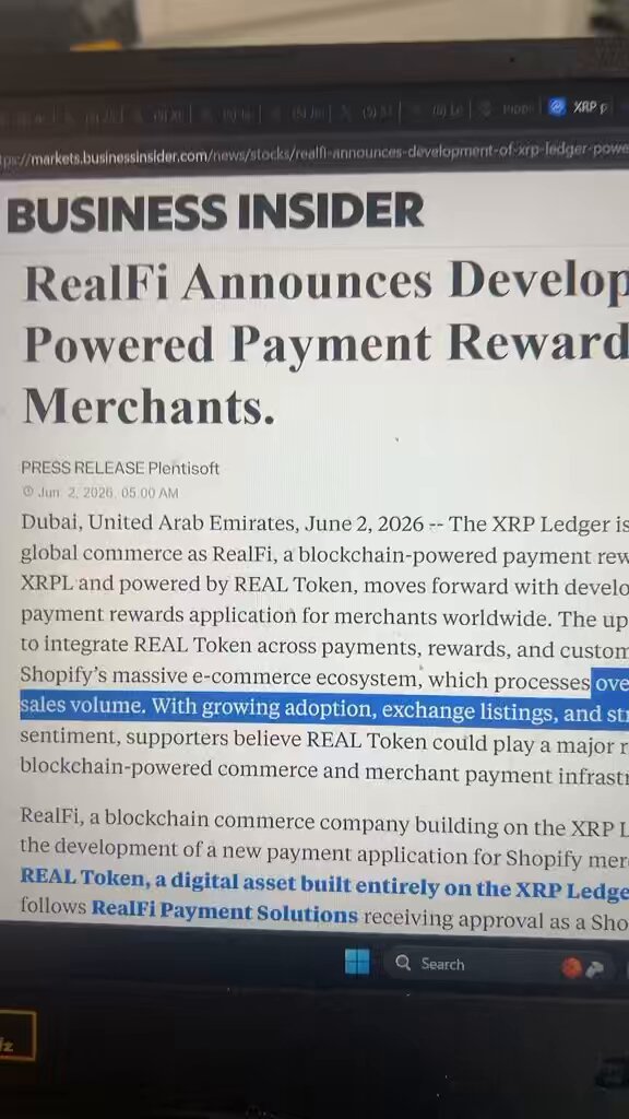 The image shows a laptop screen displaying an article about Ripple cryptocurrency. The text on the screen indicates that Ripple has been confirmed by multiple parties, including Ripple Ledger and RipplePayment Solutions. This news release highlights Ripple's development of powered payment reward merchants, which could potentially lead to increased adoption of Ripple as a payment method for businesses.