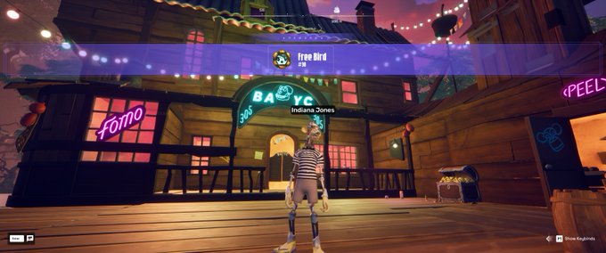 A screenshot from a video game showing a character standing in front of a building labeled 'BABYC', with neon signs reading 'Fomo' and 'PEEL', and a player name 'Free Bird' displayed at the top.
