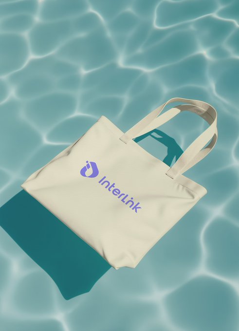 A cream-colored tote bag featuring the purple InterLink logo floats on a turquoise water surface, visually reinforcing the post's introduction to the InterLink Network as a Web3 ecosystem. The bag's branding aligns with the "InterLink 101" educational thread aimed at newcomers.