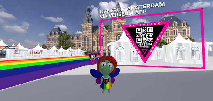 A virtual avatar stands in a 3D scene featuring white tents and a rainbow path, with text reading "LIVE FROM AMSTERDAM VIA VERSEUM APP" alongside the METAVERSE VERSEUM FOUNDATION logo and QR code.