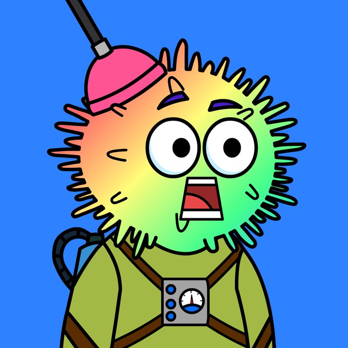 A cartoon illustration shows a rainbow-colored fuzzy character with spiky fur, wide eyes, and an open mouth, wearing a green suit with a chest device and a pink antenna-like attachment on its head.