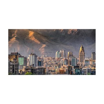 A scenic landscape showing a sprawling cityscape at the base of a massive mountain with a waterfall, set against a dramatic, cloudy sky.