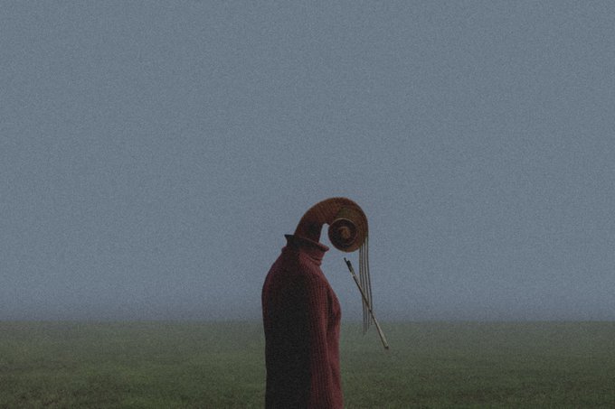 A figure draped in a maroon cloak stands in a foggy field, their head replaced by an ornate brass speaking trumpet with dangling cords, evoking the surreal idea of "The Voice of the Mind." The muted, dreamlike landscape mirrors the contemplative "gm" greeting and the post's reference to a 1/1 generative artwork living on SR.
