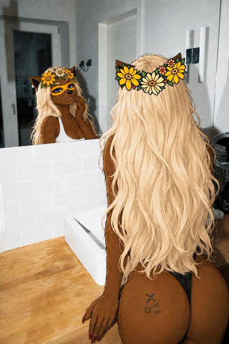 A woman with long blonde hair and a yellow sunflower crown poses in front of a bathroom mirror, her reflection showing her face, creating a selfie-style image that aligns with the post's birthday greeting to @honey_xrp.