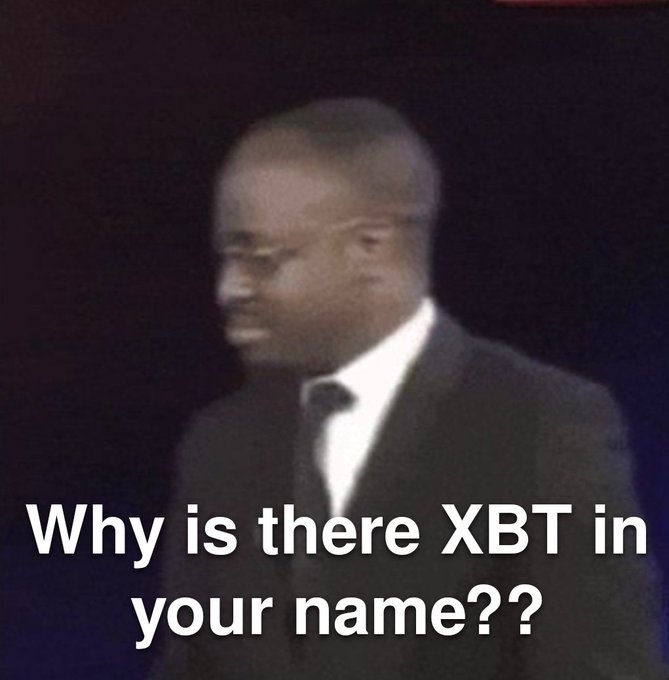 A meme image featuring a man in a suit and glasses, with text reading 'Why is there XBT in your name??'