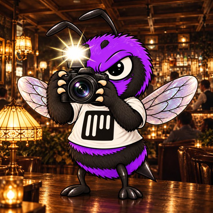 A cartoon illustration of a purple and black bee-like creature holding a DSLR camera with a flash, wearing a white t-shirt with a barcode design, set against a warm, dimly lit bar background.