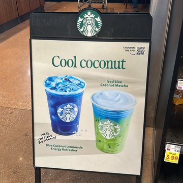 Starbucks storefront sign advertising 'Cool coconut' drinks, specifically the 'Iced Blue Coconut Matcha' and 'Blue Coconut Lemonade Energy Refresher' for $5.95.