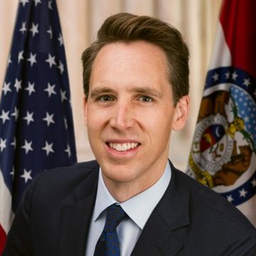 A photo of Senator Josh Hawley, a Republican from Missouri, dressed in a dark suit and patterned tie, smiling in front of an American flag and the Missouri state flag, accompanying news about his support for the CLARITY Act with proposed changes to protect small community banks from stablecoin yield competition.