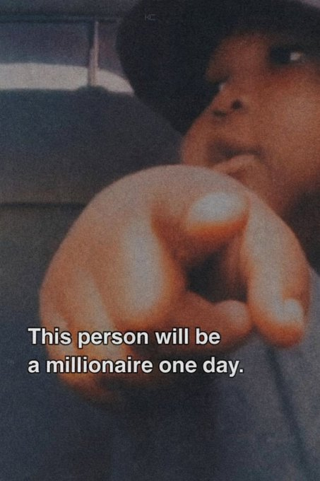 A person wearing a cap points their finger toward the camera, with a text overlay reading "This person will be a millionaire one day." The image has a humorous, motivational meme-like quality.