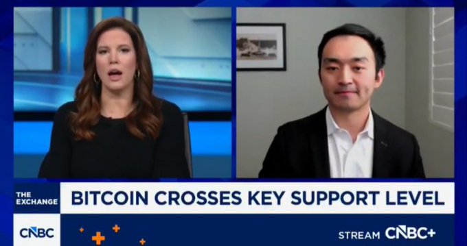 A female CNBC anchor on "The Exchange" speaks with a male guest via remote video, with the on-screen headline reading "BITCOIN CROSSES KEY SUPPORT LEVEL." The split-screen interview setup aligns with the post's discussion of Pantera Capital's bullish outlook on Bitcoin's reversal following its recent pullback.