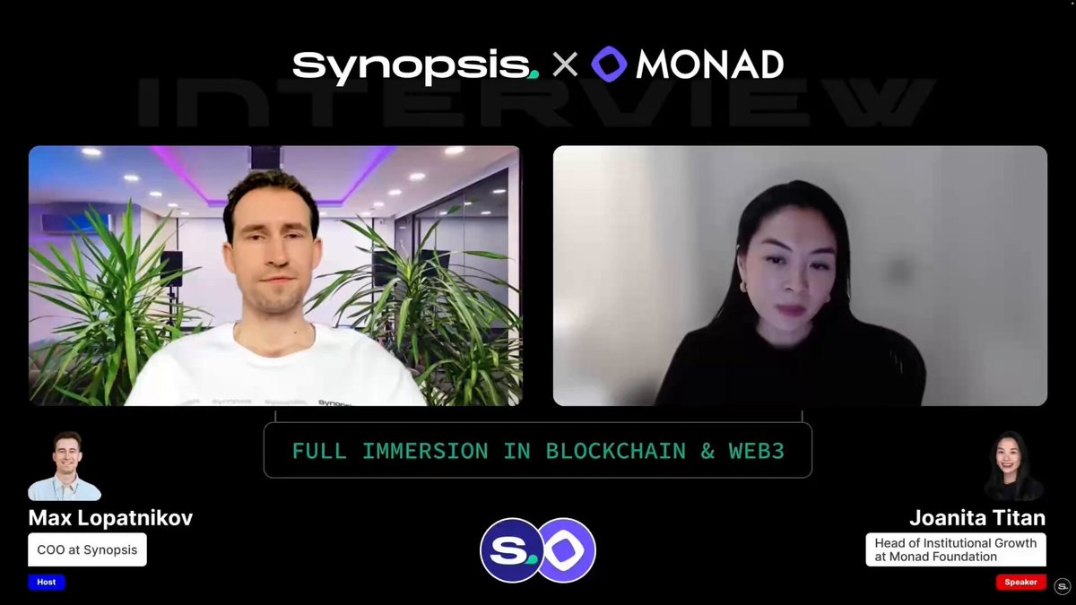 The image shows two people sitting across from each other, with one person wearing a white shirt and the other wearing black. They are both looking at the camera while having an interview or discussion. The background of the image features a computer screen displaying a video conference call between two individuals, who appear to be discussing EVM compatibility for institutions.
