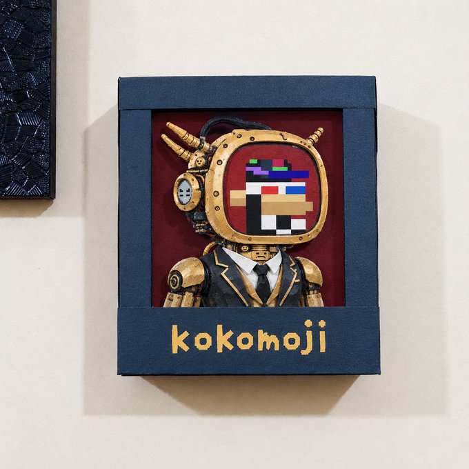 A blue box art piece featuring a steampunk-style robot in a suit with a pixelated face, labeled 'kokomoji'.