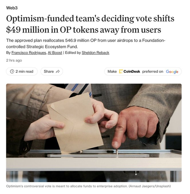 The image shows a CoinDesk Web3 news headline reading "Optimism-funded team's deciding vote shifts $49 million in OP tokens away from users," with a subheading noting the approved plan reallocates 546.9 million OP from user airdrops to a Foundation-controlled Strategic Ecosystem Fund. Below the headline is a stock photo of a person slipping a brown envelope to another person's hand, visually symbolizing the under-the-table or controversial nature of the token reallocation from users to a centralized fund.