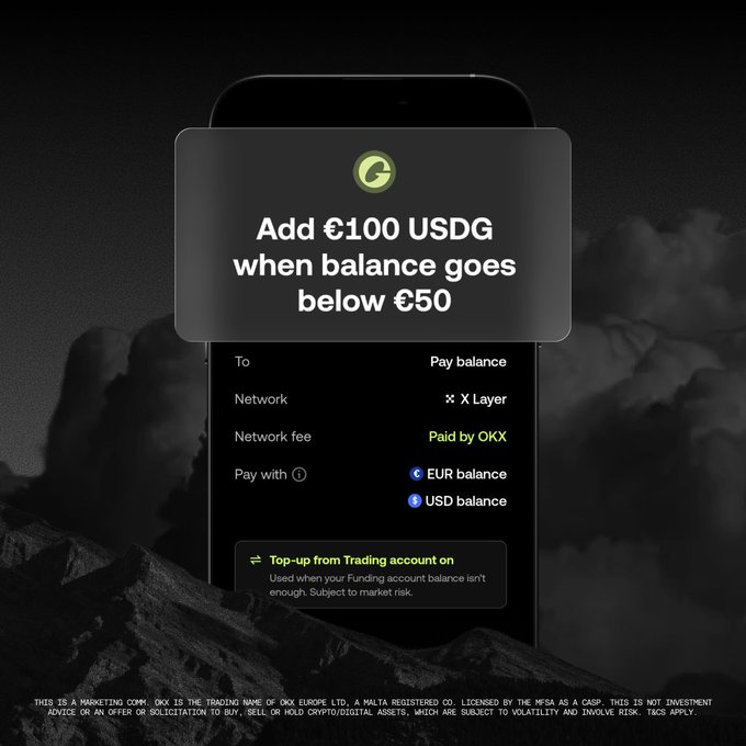 In the image, there is a black cell phone screen displaying an advertisement for a USDC mobile payment service app. The advertisement offers users the opportunity to add £100 USDC to their account when balance goes below 50, with a top-up option available for auto payments if they are below this limit. The app features options such as network fees and how much of the balance will be paid in USDC (Euros), and is set against an image of a mountain range. This could suggest that the advertisement targets users who enjoy outdoor activities or appreciate natural scenery, appealing to their interests while promoting the mobile payment service.