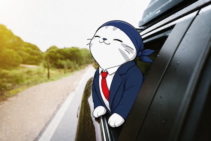 An illustration of a cartoon white seal wearing a navy blue suit, red tie, and bandana, smiling with closed eyes while leaning out of a car window on a tree-lined road.