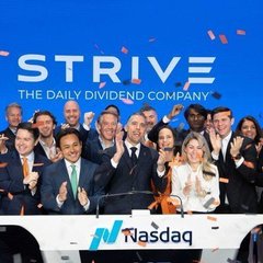 A group of people celebrate on the Nasdaq podium beneath the "STRIVE - The Daily Dividend Company" branding, marking the Bitcoin treasury company's milestone as $ASST reached an all-time high market cap of $2.5 billion with shares surging to $27.